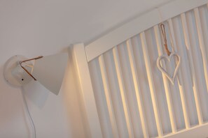 Un plafond blanc avec une lampe fixée au mur et un décor en forme de cœur.