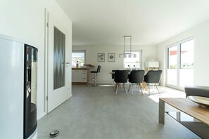 A modern kitchen with a dining area, large windows, and a minimalist design. - High-end furnishings with a fireplace, about 350 meters from the beach, sleeps up to 6, Wi-Fi (Breege)