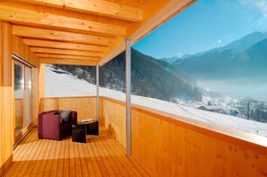 A wooden balcony with a view of a snowy mountain landscape. - Chalet With Fireplace and Garden (Gaschurn)