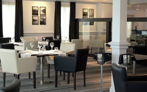 A restaurant with tables set for dining, chairs, and wine glasses. - St Mellion International Resort (Saltash)