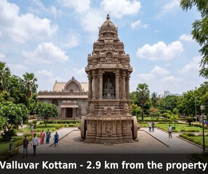 A temple with a central statue, surrounded by a well-maintained garden and a large building in the background. - Saver Double Ambience Home (Chennai)