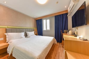 A hotel room with a bed, a desk, a chair, a television, and an air conditioning unit. - 7 Days Inn Sea World 2nd Branch (Shenzhen)