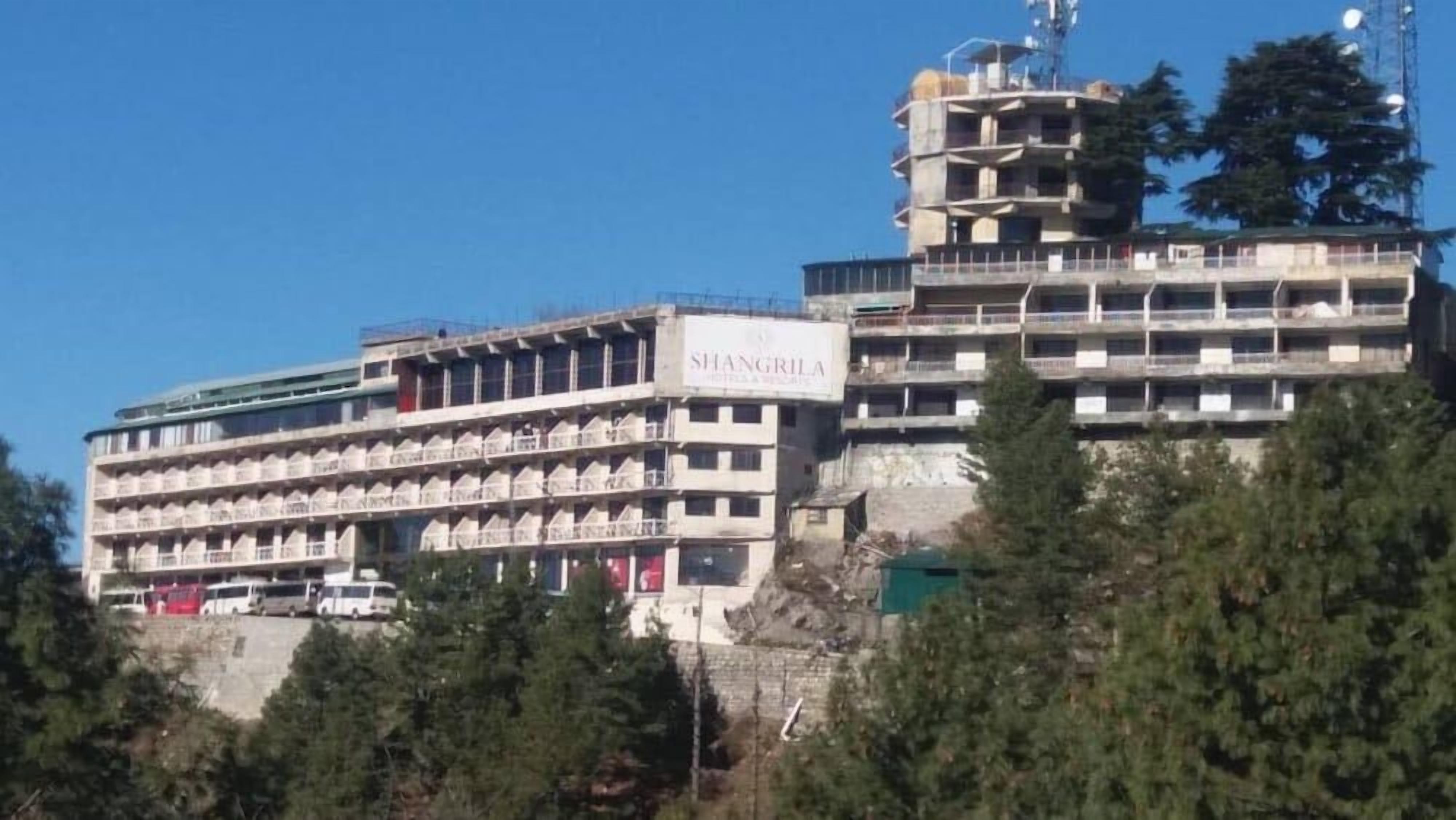 A multi-story building with a sign that reads 'SHANGRILA.'