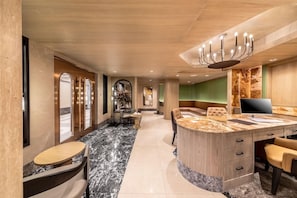 A modern hotel lobby with a marble floor, a central reception desk, and a seating area. - Court Wing Hotel Sukhumvit Bangkok (Bangkok)