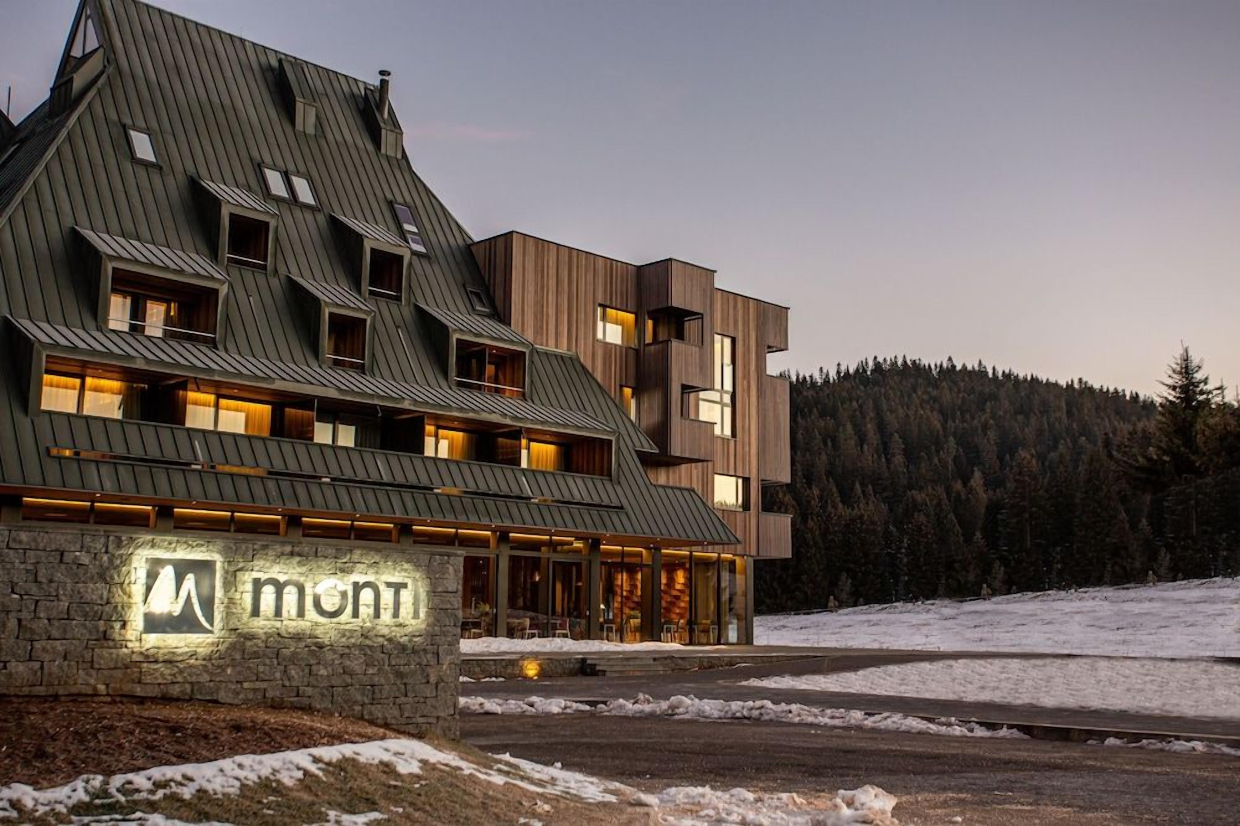 A modern building with a stone facade and a sign that reads 'mont.'