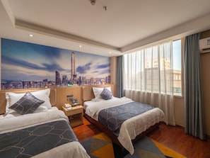 A hotel room with two beds, a cityscape mural, a window with curtains, and a wooden headboard. - Chonpines Hotel (Shenzhen)