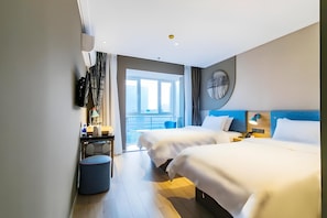 A hotel room with two beds, a desk, a chair, a round wall clock, and a view of the city. - Home Inn (Tianjin)