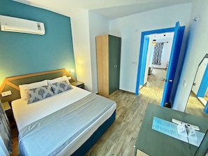 A hotel room with a bed, a desk, and a wardrobe. - Zehra Tatil Koyu (Fethiye)