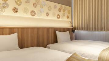 A hotel room with two beds, a wooden headboard, and a decorative wall panel.
