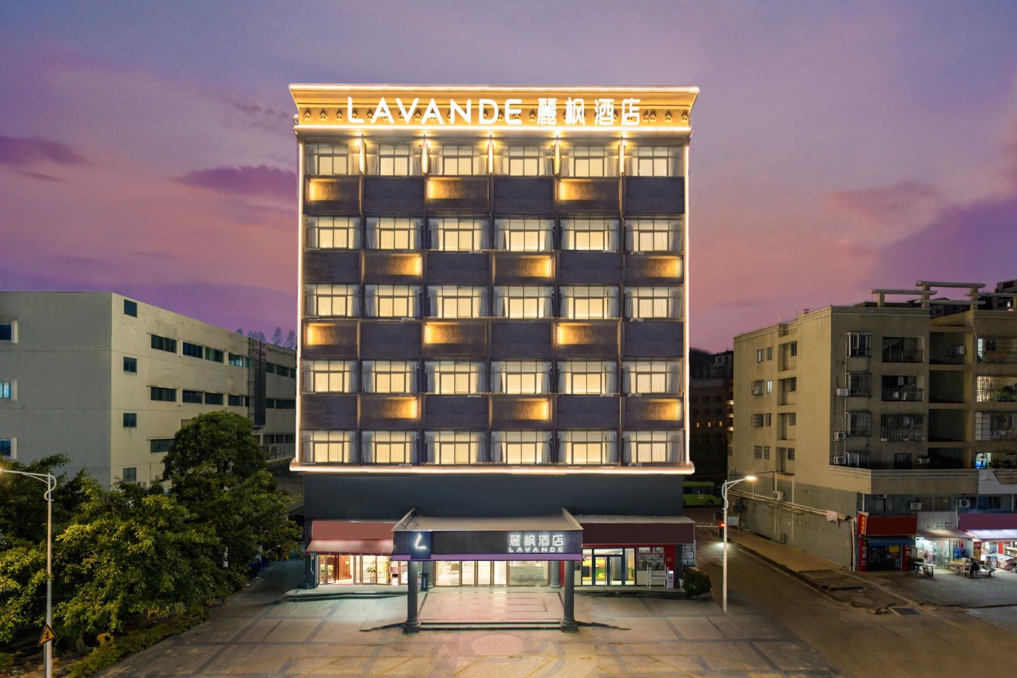 A multi-story hotel building with a prominent sign at the top.