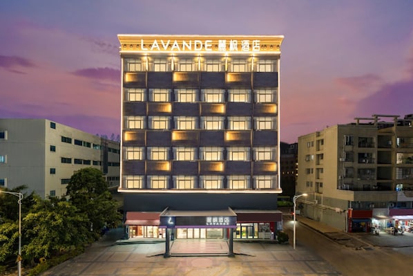 A multi-story hotel building with a prominent sign at the top. - Lavande Hotel (Zhuhai)