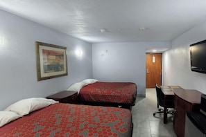 A hotel room with two beds, a desk, a chair, a television, and a painting on the wall.