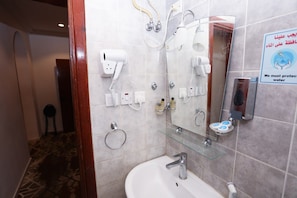 A modern bathroom with a glass shower enclosure, a sink, and a mirror. - Raafat Al Marzouki Al Kutbi Hotel (macch)