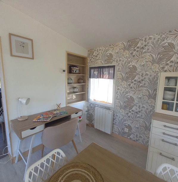 A room with a desk, chair, radiator, and a window with curtains. - A Little Paradise (Sanghen)