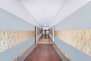 A long hallway with patterned walls and a patterned carpet.