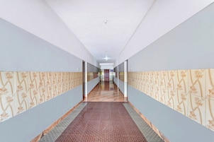 A long hallway with patterned walls and a patterned carpet.