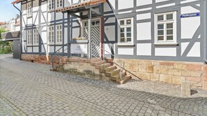 A traditional half-timbered building with a stone staircase leading to the entrance. - Vrbo Property (Bad Hersfeld)