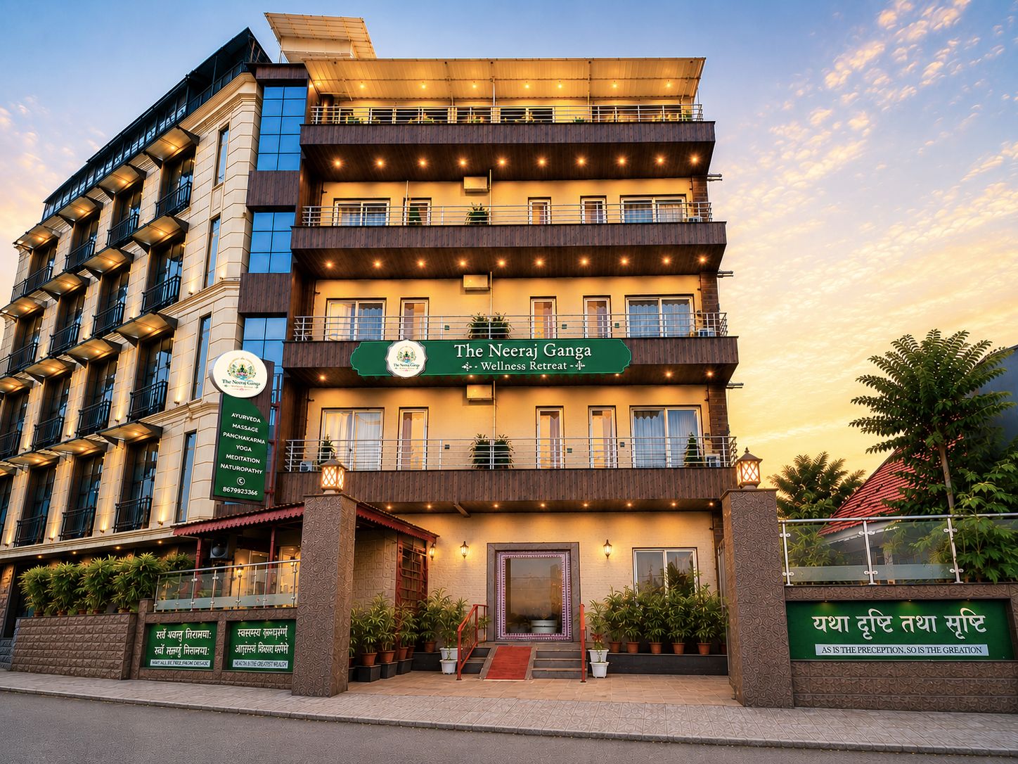 A multi-story wellness retreat building with balconies, a signboard, and potted plants.