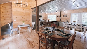 A wooden interior with a dining area, kitchen, and a staircase. - 4-bedroom farmhouse near Pataskala with proximity to Columbus and Hocking Hills (Pataskala)