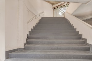 A staircase with a handrail leading to a landing.