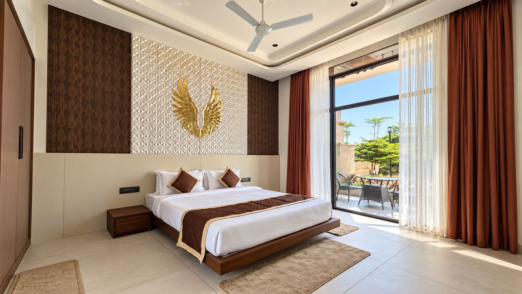 A modern bedroom with a large bed, a ceiling fan, and a view of the outdoors through a glass door.