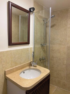 A bathroom with a sink, mirror, and shower. - Perfect 1-bedroom apartment with AC in welcoming Giza Governorate (Giza Governorate)