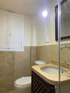 A bathroom with a toilet, sink, and mirror. - Perfect 1-bedroom apartment with AC in welcoming Giza Governorate (Giza Governorate)