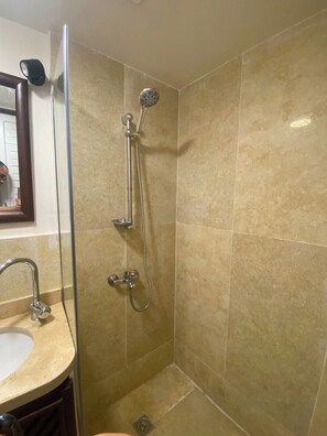 A bathroom with a shower, a sink, and a mirror. - Perfect 1-bedroom apartment with AC in welcoming Giza Governorate (Giza Governorate)