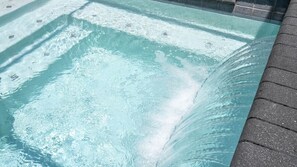 A clear pool with visible water movement, surrounded by a tiled edge. - 4BR Le Reve Resort Pool Near Disney & Universal (Kissimmee)