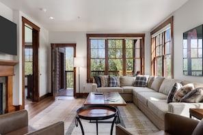 A spacious living room with a large sectional sofa, a coffee table, and a fireplace. - Outpost: Grand View 3220 - Has A/C! (Jackson)