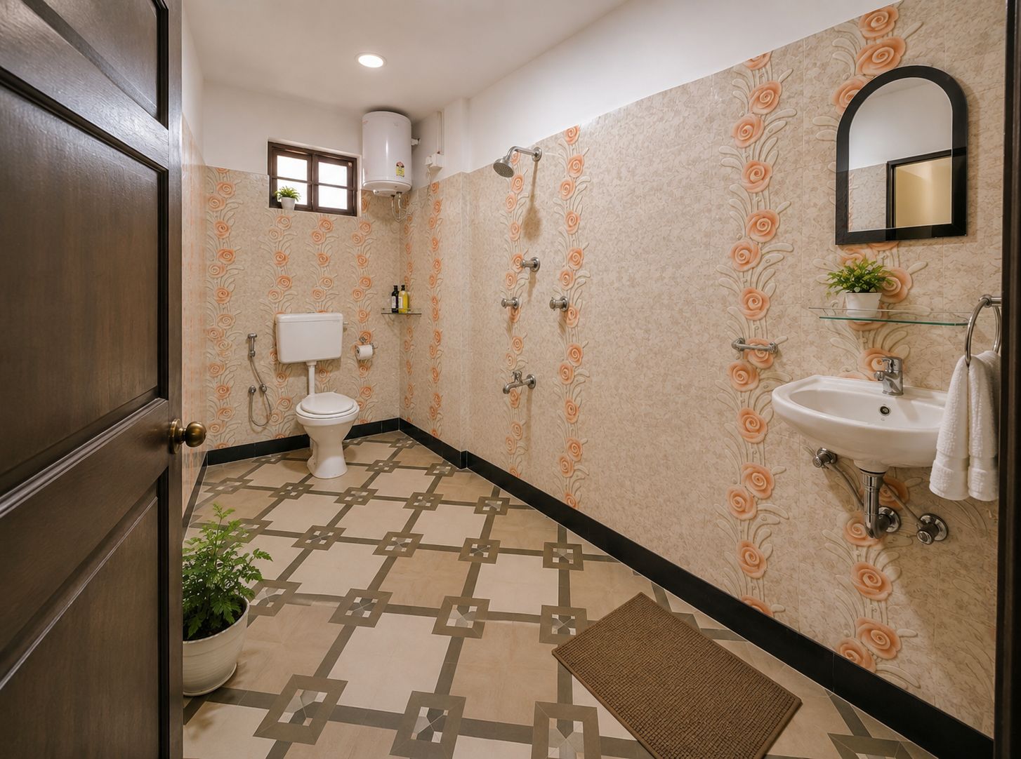 Un baño con inodoro, lavamanos, ducha y una planta en maceta.
