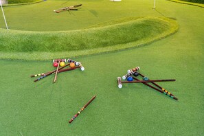 A golf course with a putting green and a bunker. - Saltwater Pool -12Hole Miniature Golf & Pickleball (South Miami Heights)