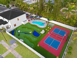A residential property with a swimming pool, tennis court, and landscaped garden. - Saltwater Pool -12Hole Miniature Golf & Pickleball (South Miami Heights)