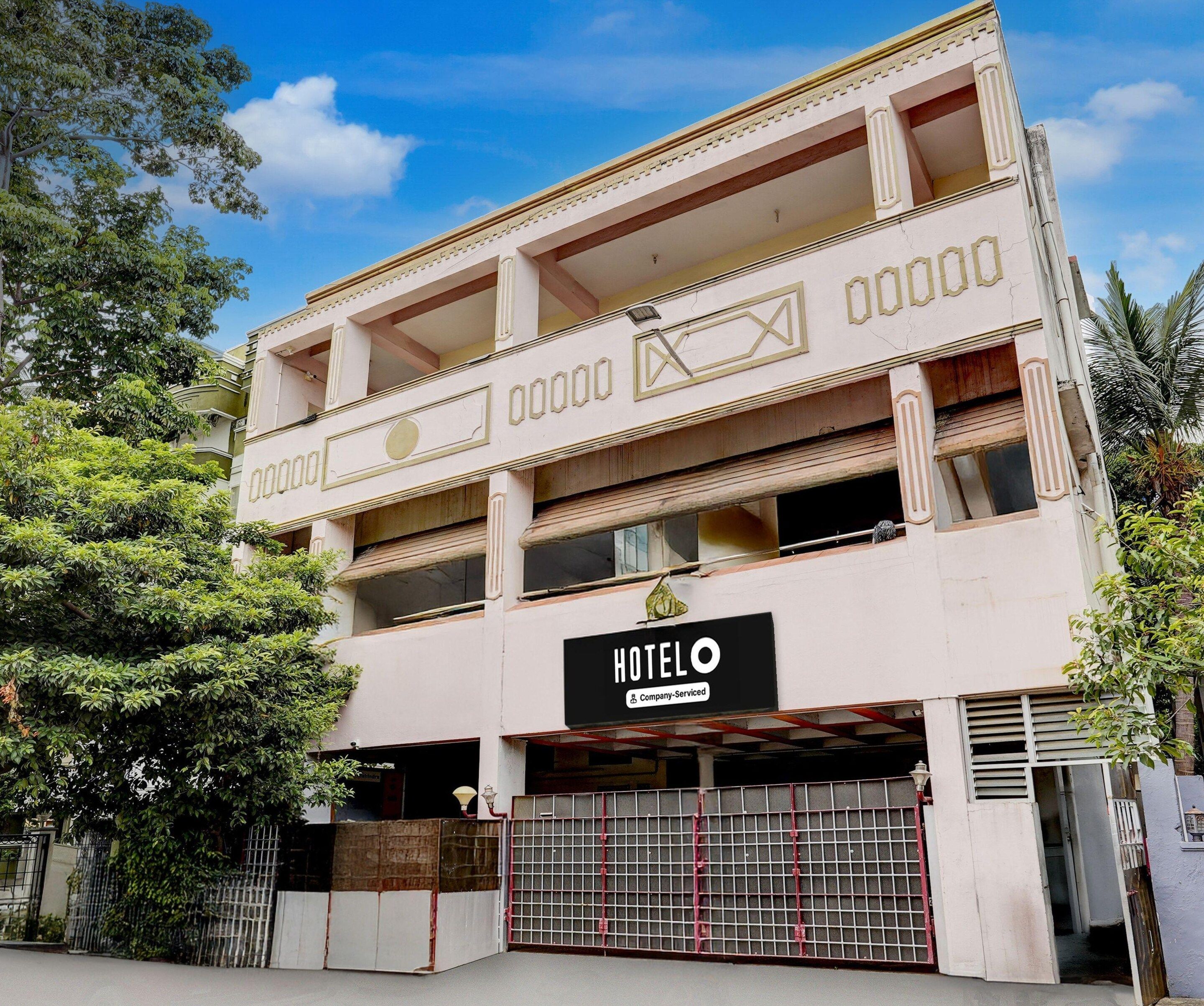 A multi-story building with a sign indicating it is a hotel.