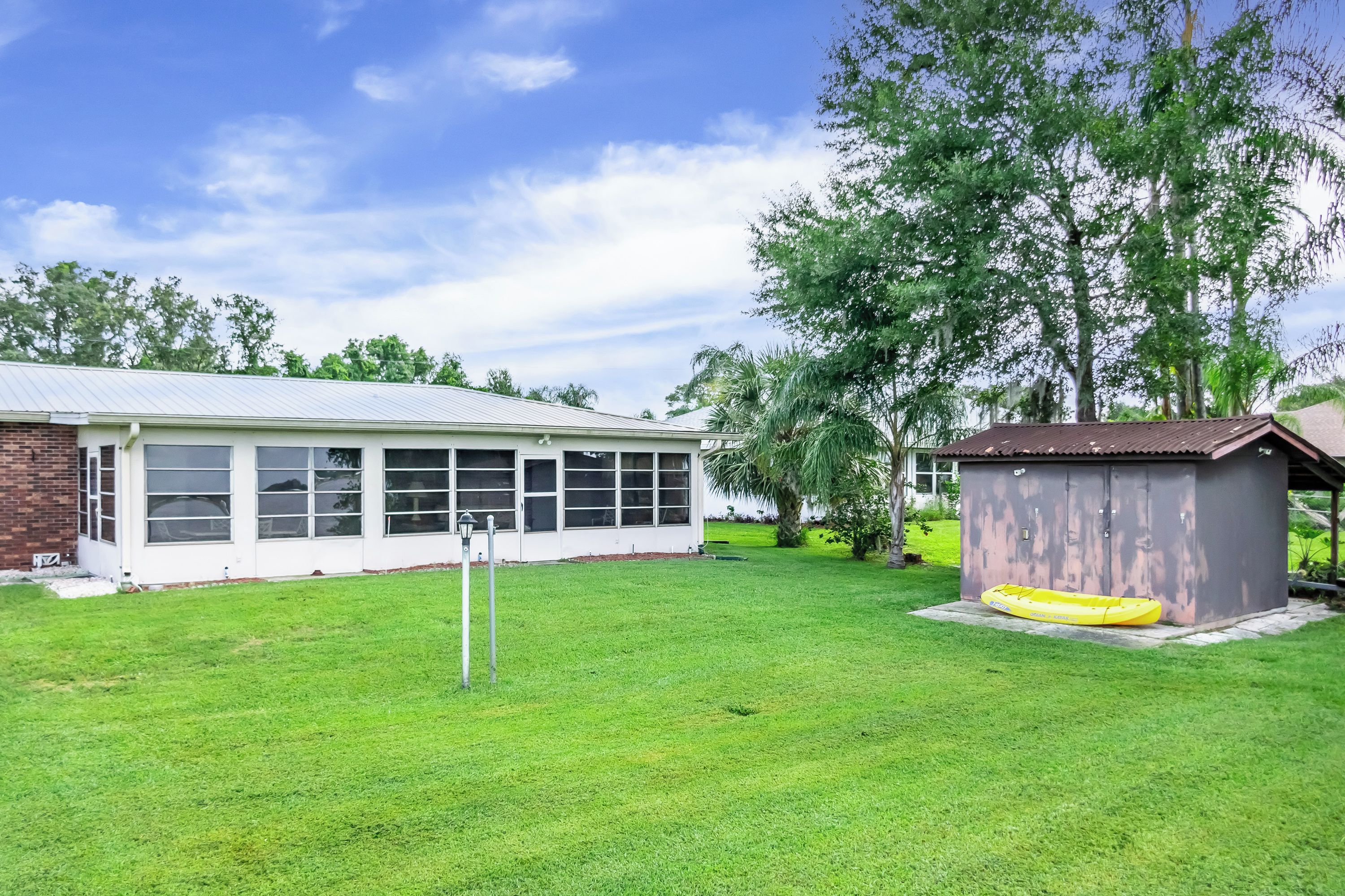 A residential property with a house, a garage, and a well-maintained lawn.