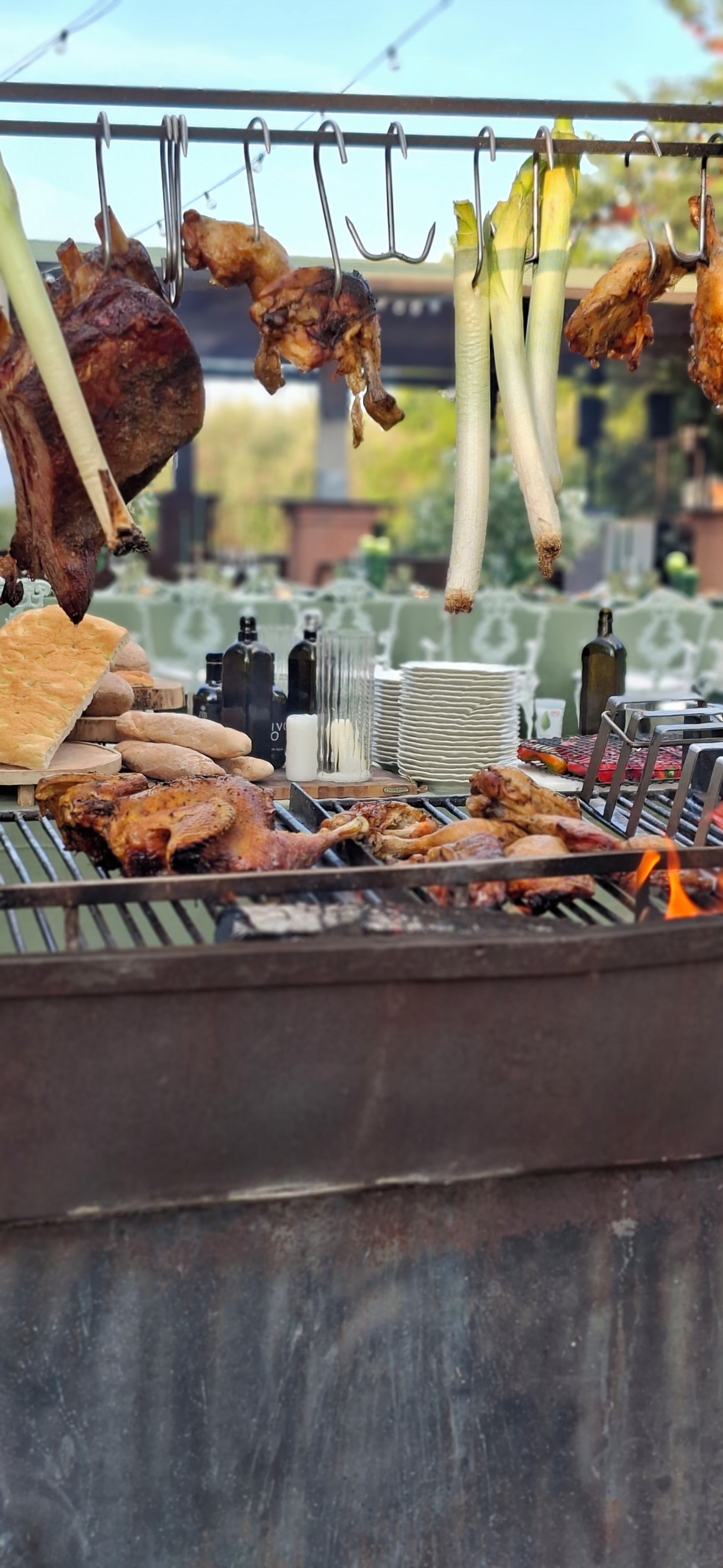 A grill with various meats and vegetables being cooked.
