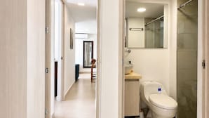 A modern bathroom with a toilet, sink, and shower. - Tropical Midnight | Sunset Views & Pool, Wi-Fi (Cartagena)