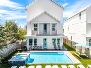 A two-story house with a swimming pool, a fenced backyard, and a wooden deck. - Shellbelle: Steps to Beach, Heated Pool & Hot Spa, Free Golf Cart, 3 Game Rooms (Miramar Beach)