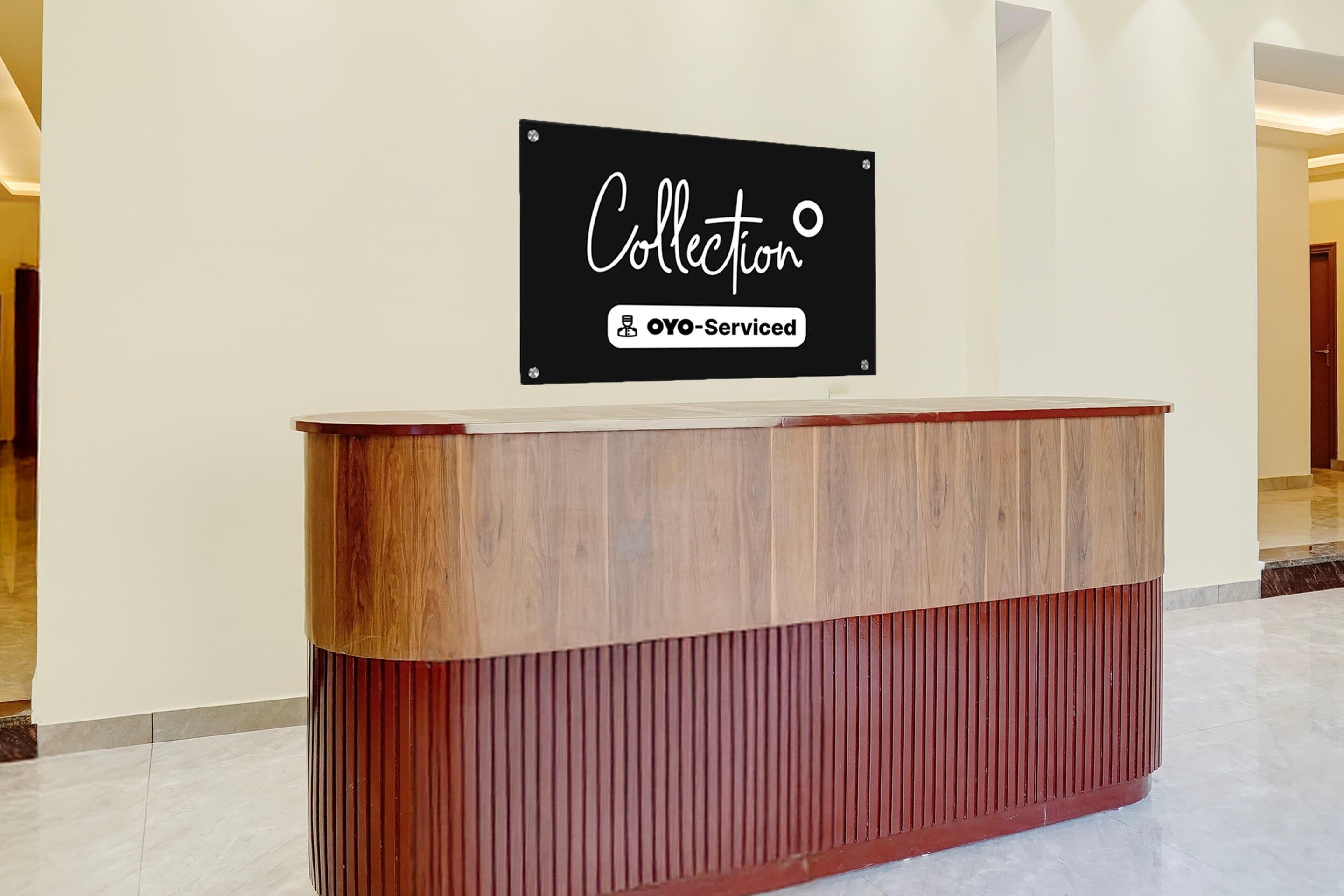 A reception desk with a sign above it that reads 'Collection' and 'YO-Serviced'.