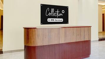 A reception desk with a sign above it that reads 'Collection' and 'YO-Serviced'.