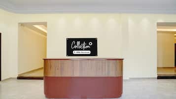 A reception desk with a sign above it.