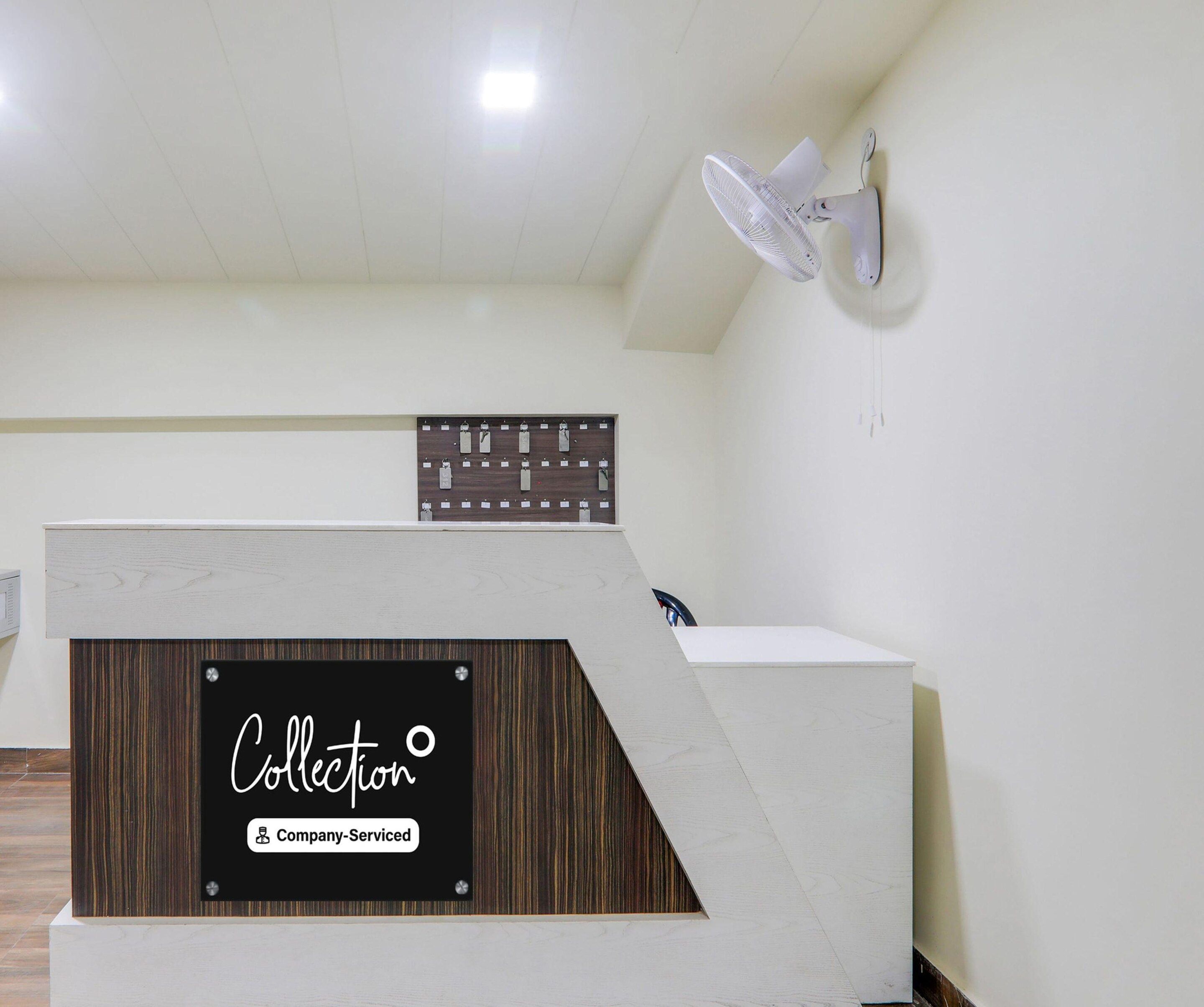 A reception desk with a sign indicating it's a company-serviced collection point.