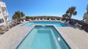 A rectangular swimming pool with two separate sections, surrounded by lounge chairs and palm trees. - 2 Oceanfront Single Family Huge Homes, 500 ft apart, 2 Private Pools, Sleeps 60 (North Myrtle Beach)