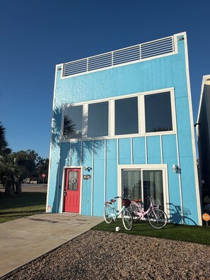 A two-story building with a red door, numbered 4534, and a bicycle parked in front. - NEW Coastal property with AMAZING waterfront views!! (Bacliff)