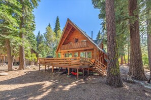 A wooden cabin with a balcony, surrounded by tall trees. - Dog-Friendly Tahoe Family Home | Tahoma (Tahoma)