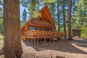 A wooden cabin with a balcony, surrounded by tall trees. - Dog-Friendly Tahoe Family Home | Tahoma (Tahoma)