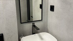 A bathroom with a white sink, a rectangular mirror, and a modern faucet. - Dream Jaiylgan (Bishkek)