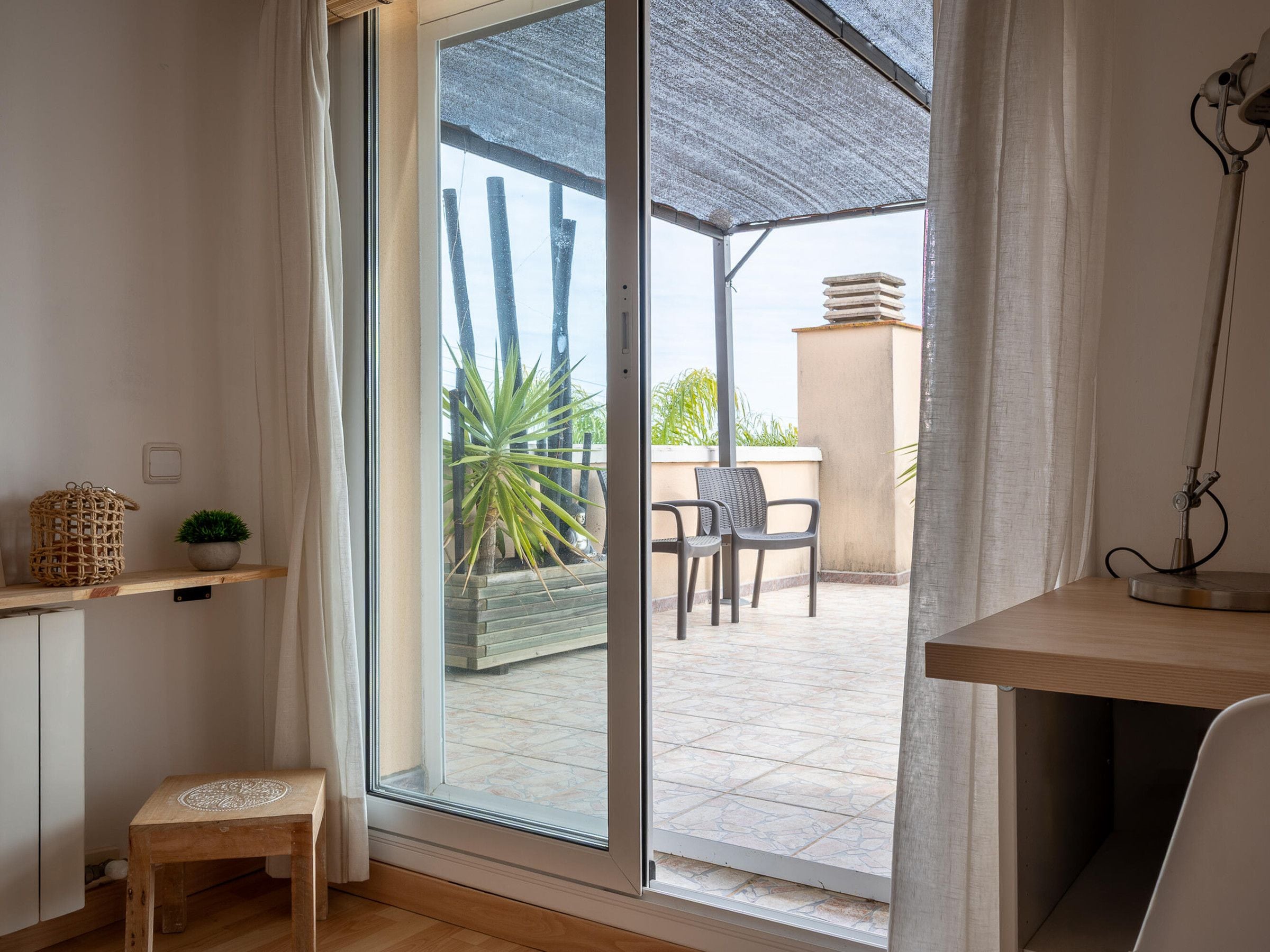 A room with a sliding glass door leading to an outdoor patio area.