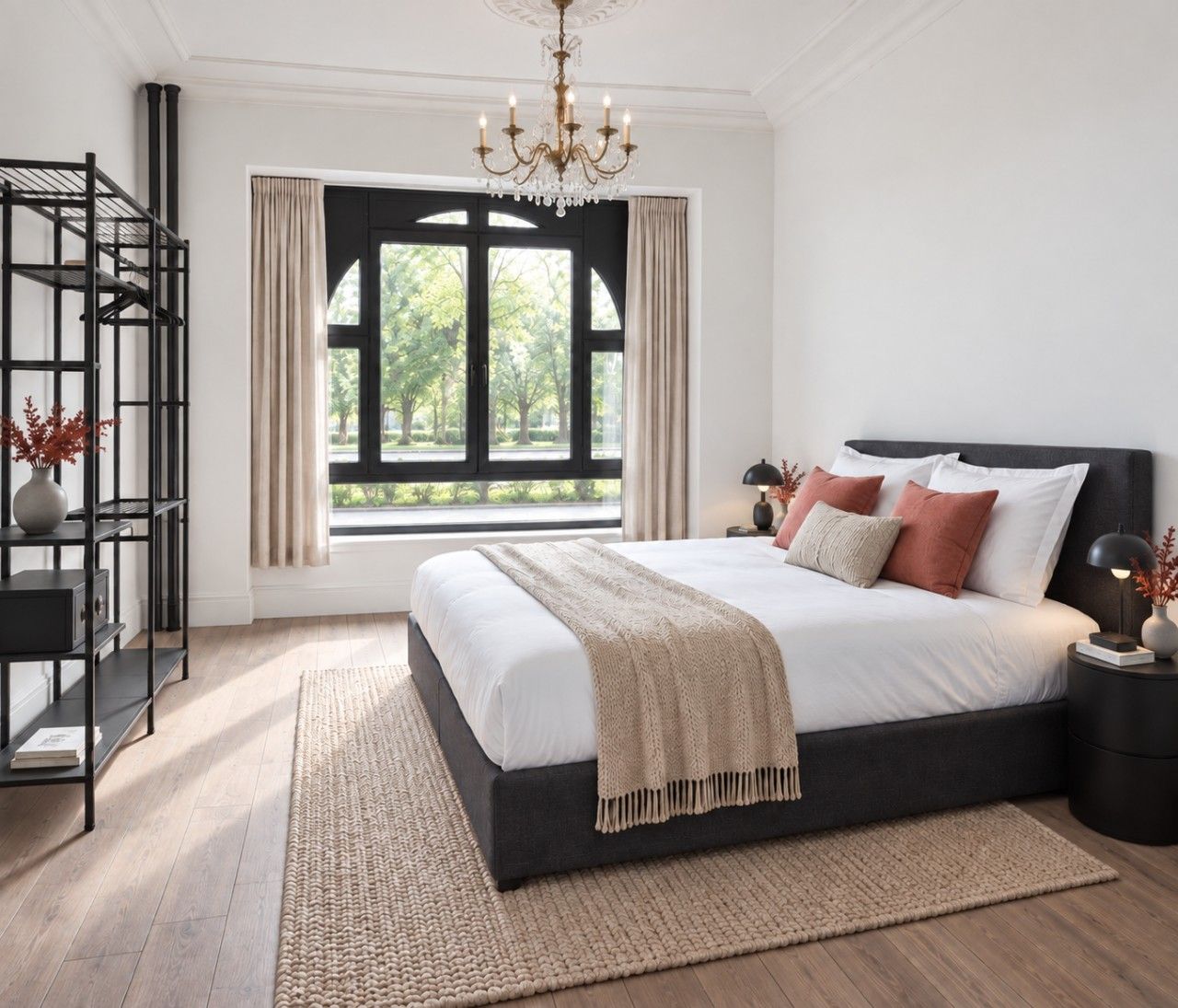 Een slaapkamer met een groot bed, een kroonluchter, een raam met gordijnen en een metalen plank met boeken.