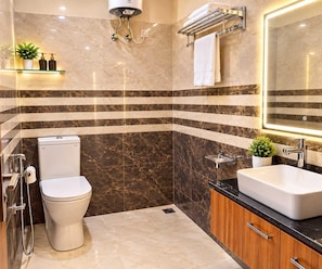 A modern bathroom with a toilet, sink, and shower.